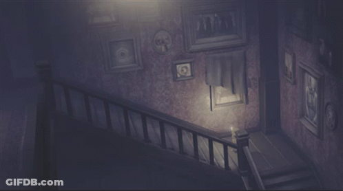 A Dark Staircase With Pictures On The Wall And A Light GIF