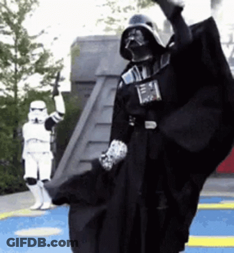 A Darth Vader Costume Is Being Worn By A Storm Trooper . GIF
