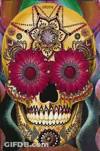 A Day Of The Dead Skull With Pink Flowers On It GIF