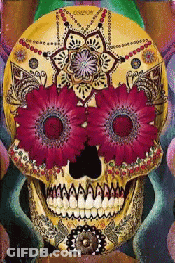 A Day Of The Dead Sugar Skull With Purple Flowers In Its Eyes GIF