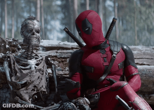 A Deadpool Sitting Next To A Skeleton In The Snow GIF