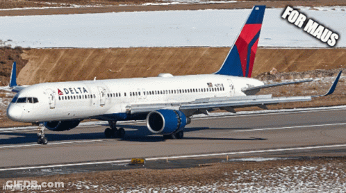 A Delta Airplane Is Sitting On The Runway GIF