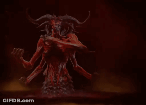 A Demon With Horns Is Holding A Skull In His Hands . GIF