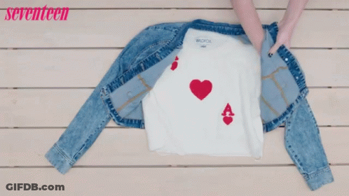 A Denim Jacket And Jeans Are On A Wooden Table With The Words Seventeen In Pink GIF