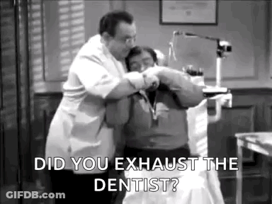 A Dentist Is Examining A Patient 'S Teeth In A Dental Office . GIF