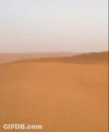 A Desert Landscape With A Grid Pattern And A Blue Sky In The Background GIF
