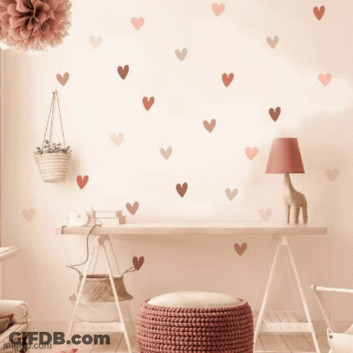 A Desk With Hearts On The Wall And A Lamp GIF