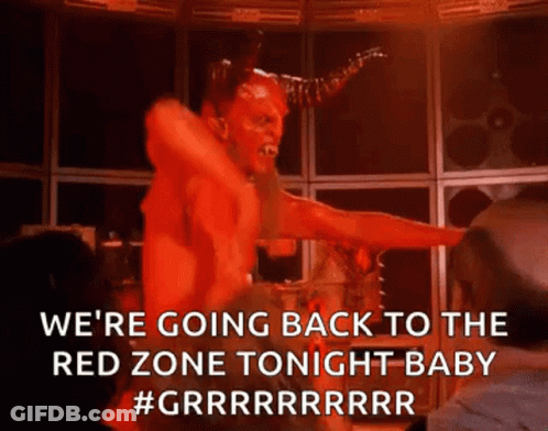 A Devil Is Dancing On A Stage In A Dark Room With A Woman . GIF