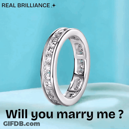 A Diamond Ring With The Words " Will You Marry Me " Below It GIF