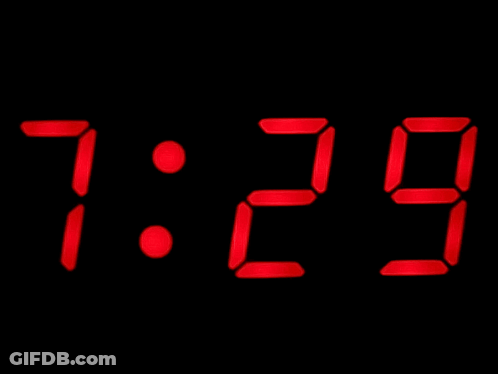 A Digital Clock Displays The Time As 7:30 On A Black Background GIF