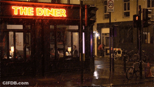 A Diner With A Neon Sign That Says The Diner On It GIF