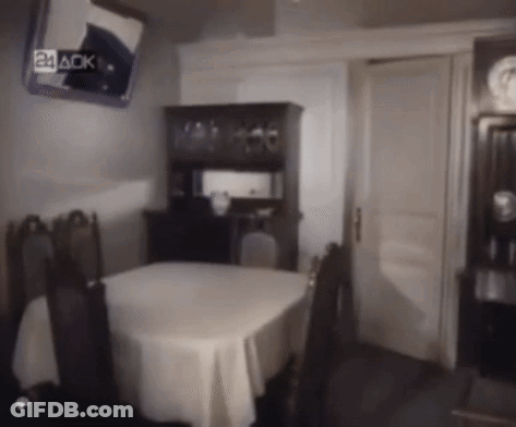A Dining Room With A Table And Chairs And A Mirror That Says 24 Aok GIF
