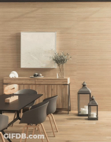 A Dining Room With A Table And Chairs And A Picture On The Wall GIF