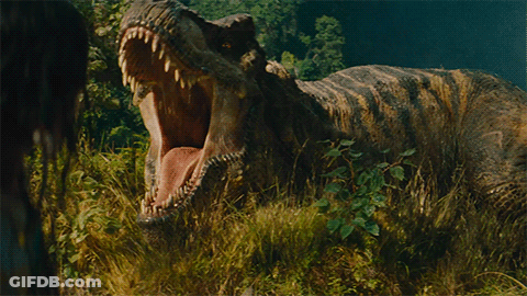 A Dinosaur With Its Mouth Wide Open Standing In The Grass GIF