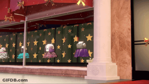 A Display Of Dresses In A Store Window With Stars On The Wall GIF