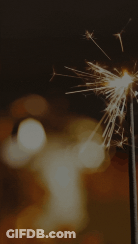 A Diwali Greeting Card With A Candle And Sparklers On It GIF