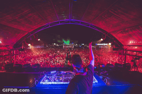 A Dj Playing Music In Front Of A Crowd With A Sign That Says ' X ' On It GIF
