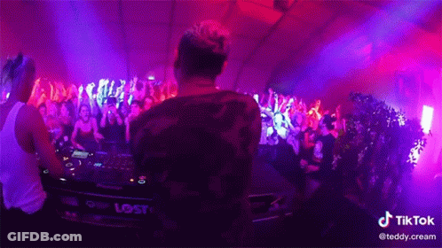 A Dj Playing Music In Front Of A Crowd With A Tiktok Watermark On The Bottom Right GIF