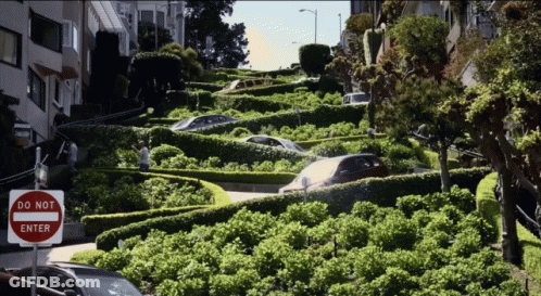 A Do Not Enter Sign Is On The Side Of A Very Narrow Street GIF