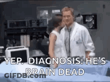 A Doctor And A Woman Are Standing Next To Each Other In A Hospital Room . The Doctor Is Talking To The Woman . GIF