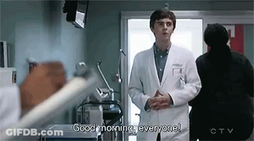A Doctor Is Standing In A Hospital Room Talking To A Patient . GIF