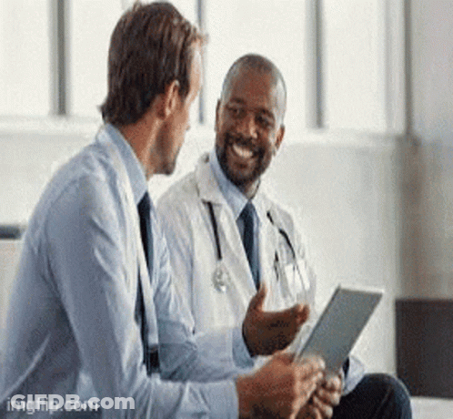 A Doctor Is Talking To A Businessman While Looking At A Tablet . GIF