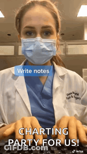 A Doctor Wearing A Face Mask Is Typing On A Keyboard . GIF