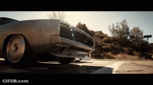 A Dodge Charger Is Parked On A Road GIF