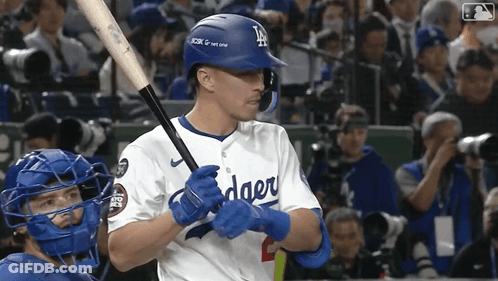 A Dodgers Baseball Player Holds A Bat In His Hands GIF