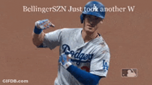 A Dodgers Baseball Player Is Flexing His Muscles On The Field GIF
