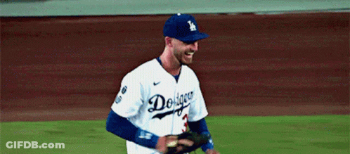 A Dodgers Baseball Player Is Smiling And Holding A Glove GIF