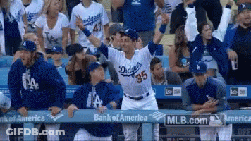 A Dodgers Baseball Player Stands In Front Of A Crowd GIF