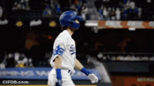 A Dodgers Baseball Player Wearing A Helmet And Gloves GIF