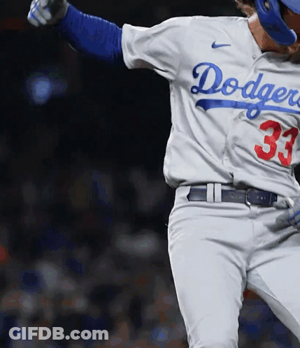A Dodgers Baseball Player Wearing Number 33 Is Swinging His Bat GIF
