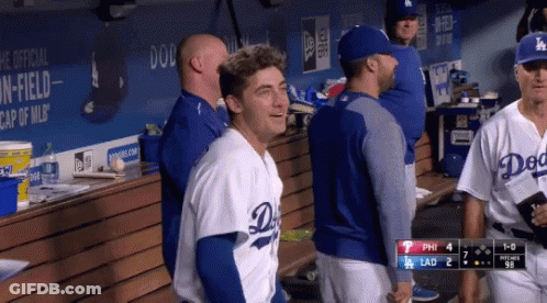 A Dodgers Player Is Standing In The Dugout Talking To Another Player GIF