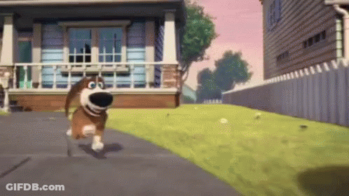A Dog Is Running Down A Street In Front Of A House . GIF