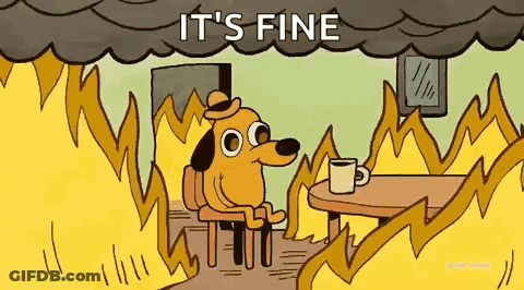 A Dog Is Sitting At A Table With A Cup Of Coffee In Front Of A Fire . GIF