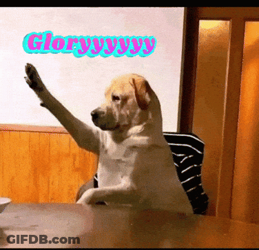 A Dog Sitting At A Table With Its Paw Up And The Words Glory Yy Yy Written On The Wall Behind It GIF