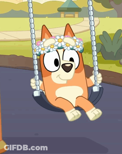 A Dog Wearing A Flower Crown Sits On A Swing GIF