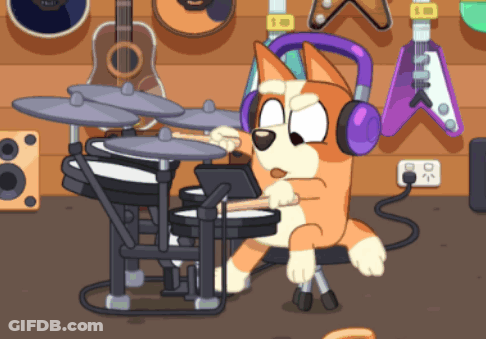 A Dog Wearing Headphones Plays Drums In Front Of Guitars GIF