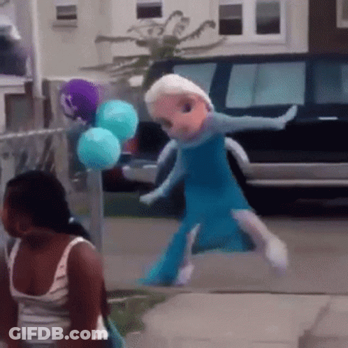 A Doll Dressed As Elsa From Frozen Is Walking Down A Sidewalk GIF