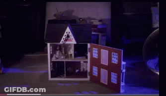 A Doll House With The Door Open And A Purple Light Behind It GIF