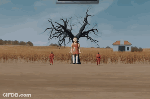 A Doll In A Red Dress Is Walking In A Field With A Man In A Red Suit Behind Her GIF