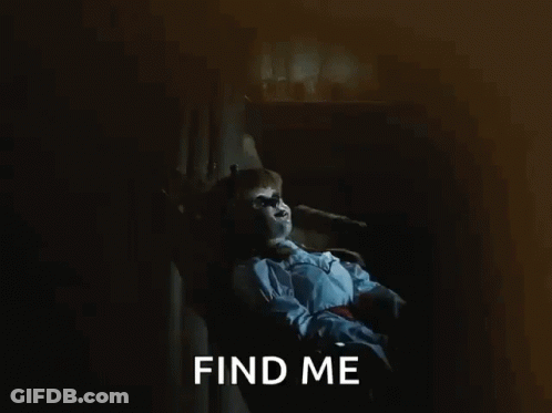 A Doll Is Sitting In A Chair With The Words Find Me Behind It GIF