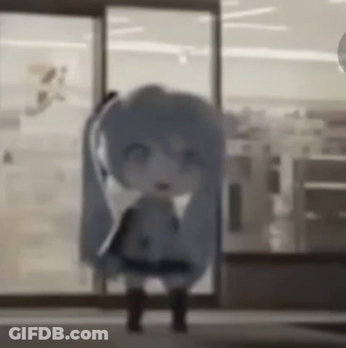 A Doll Is Standing In Front Of A Glass Door In A Room . GIF