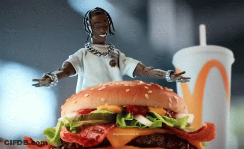 A Doll Is Standing On Top Of A Hamburger With A Drink In The Background GIF