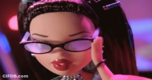 A Doll Wearing Glasses And A Necklace Is Covering Her Ear GIF
