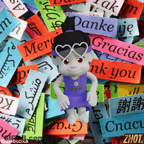 A Doll Wearing Sunglasses And A Zhotcita Shirt Stands In Front Of A Pile Of Colorful Stickers GIF