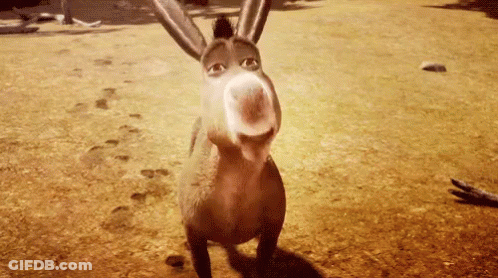 A Donkey From Shrek Is Standing On A Dirt Field Looking At The Camera . GIF