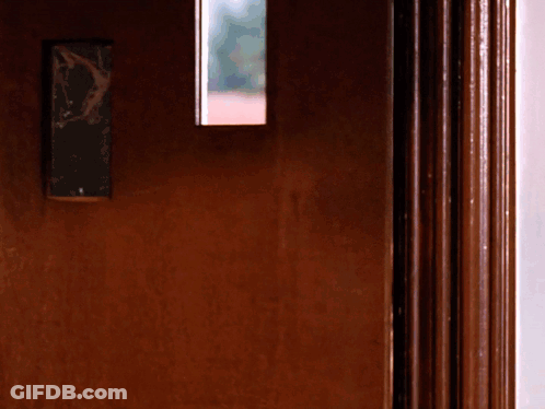 A Door With A Broken Mirror On It GIF